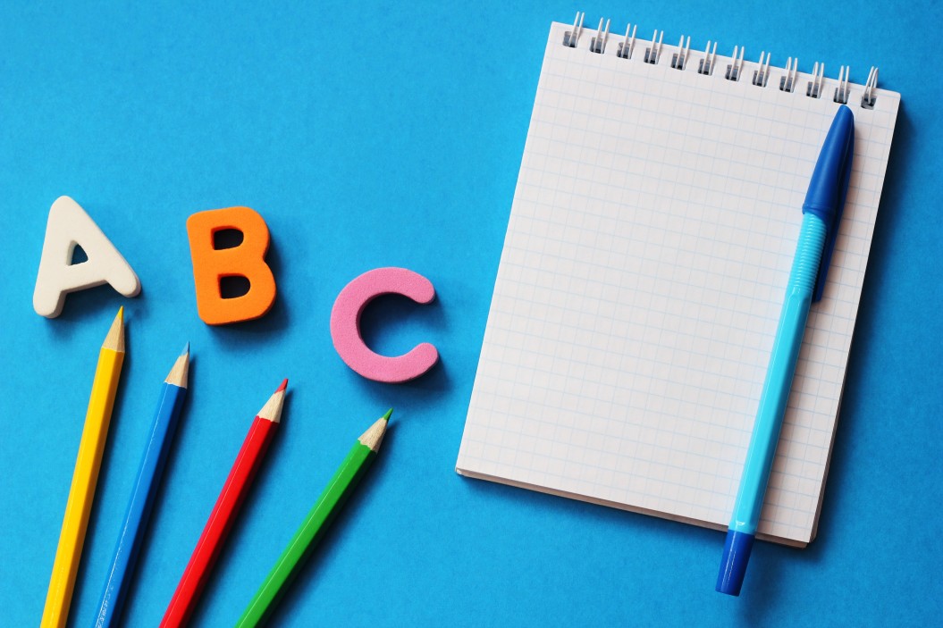 abc-the-first-letters-of-the-english-alphabet-on-a-blue-background-notebook-and-pen-pencils-of_t20_E4GveJ